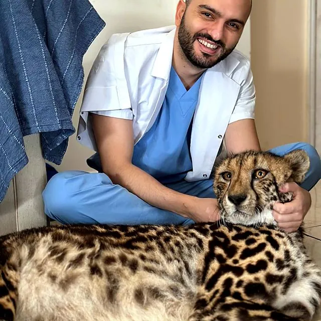 Dr Furkan with a young cheetah patient