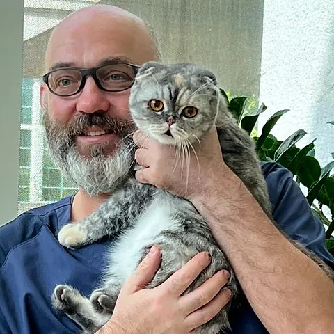 Dr Piotr holding Angela&rsquo;s Scottish Fold cat