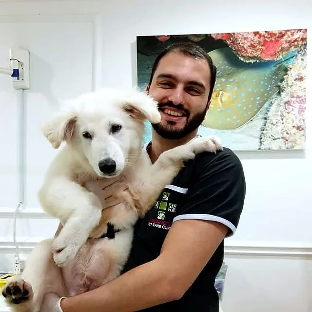 Dr Furkan holding a fluffy white puppy at Advanced Pet Care Clinic