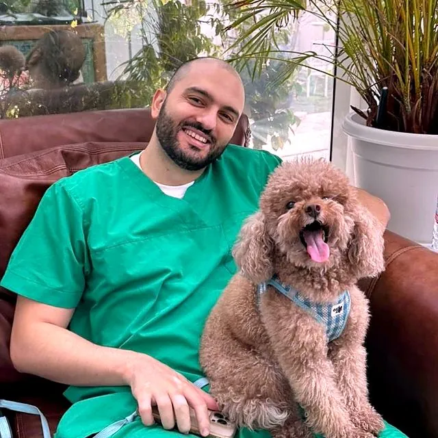 Dr Furkan relaxing with a happy toy poodle