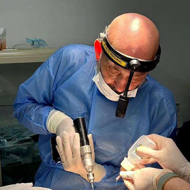 Dr Piotr performing precision surgery with a headlamp