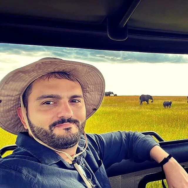 Dr Furkan on safari with elephants in the background