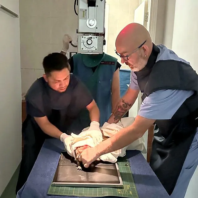 Dr Piotr and the team positioning a patient for an X-ray