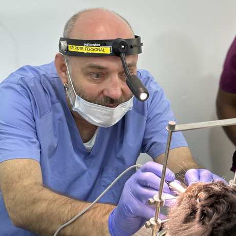 Dr Piotr performing dental work under magnification