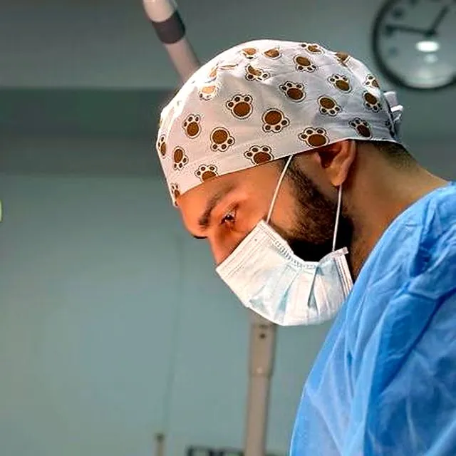 Dr Furkan in theatre, focused on a surgical procedure